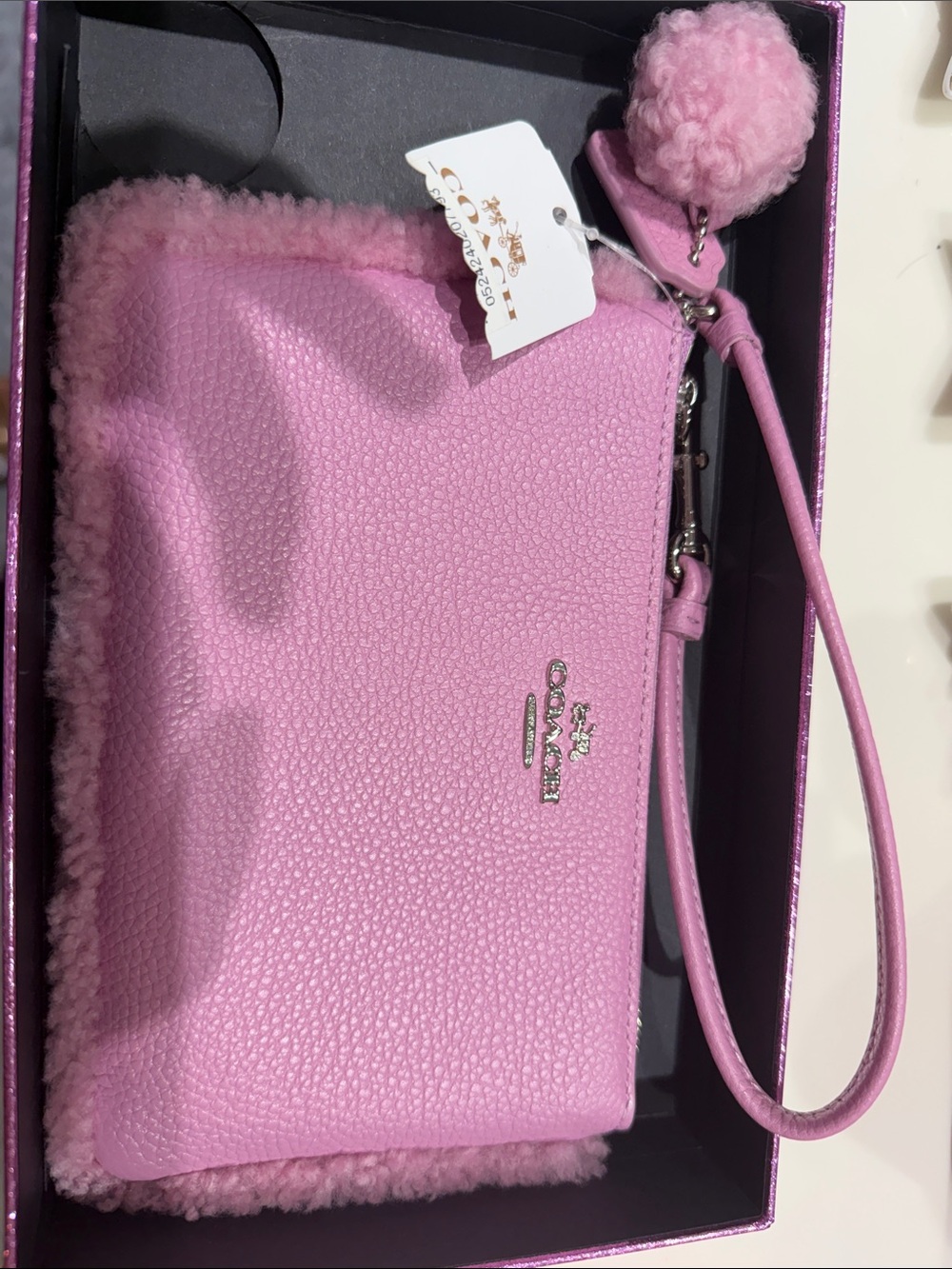 Coach Pink Pebbled Leather Wristlet with Shearling Pom Charm
